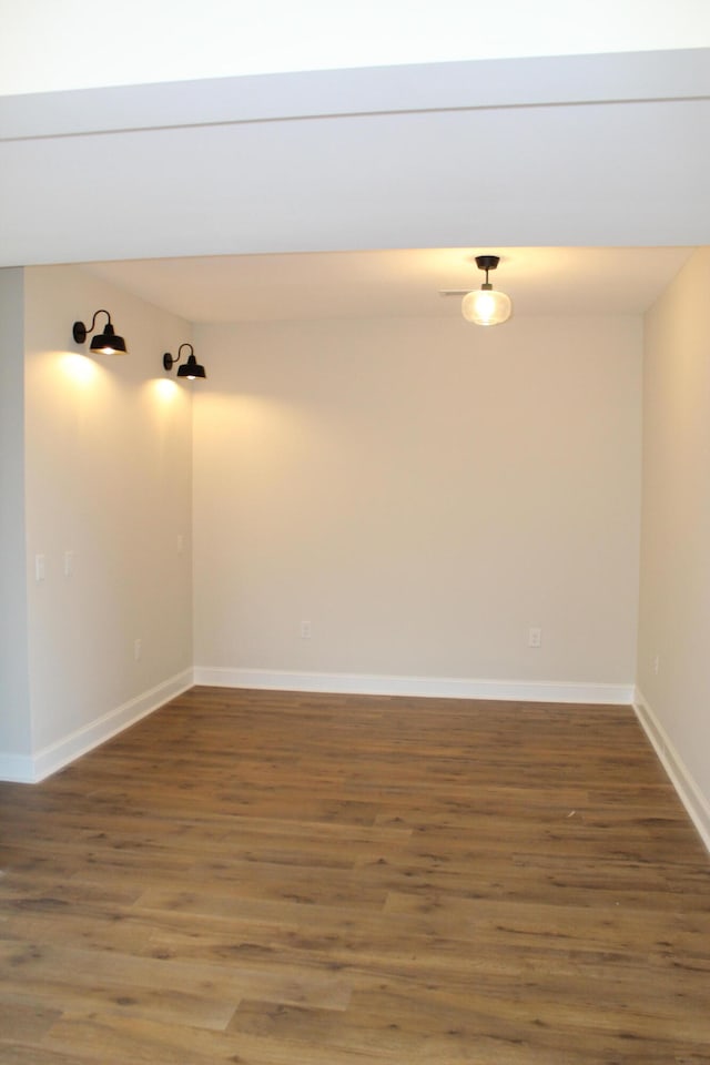 empty room with dark wood-type flooring