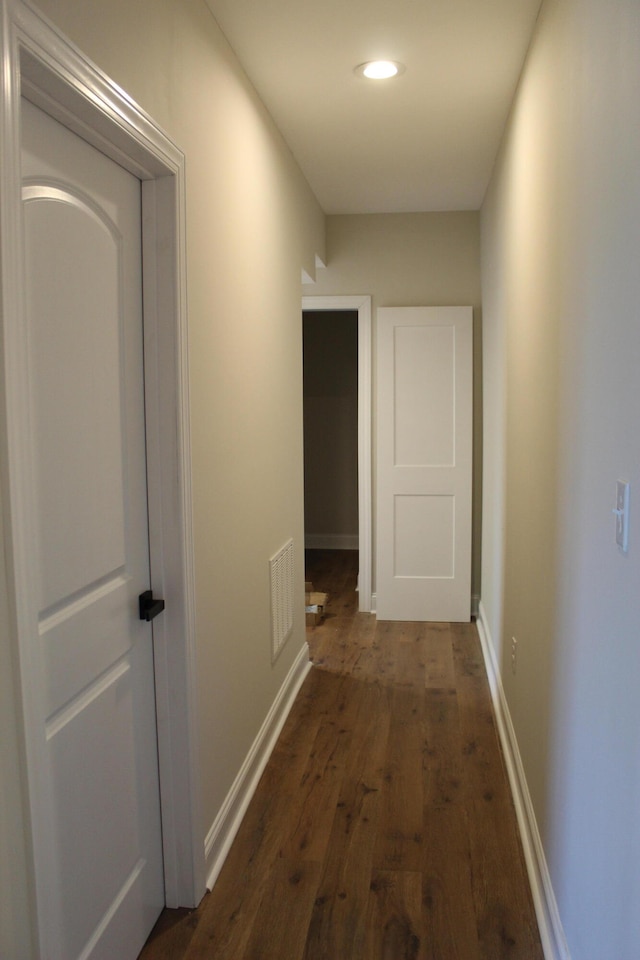 corridor with dark hardwood / wood-style floors