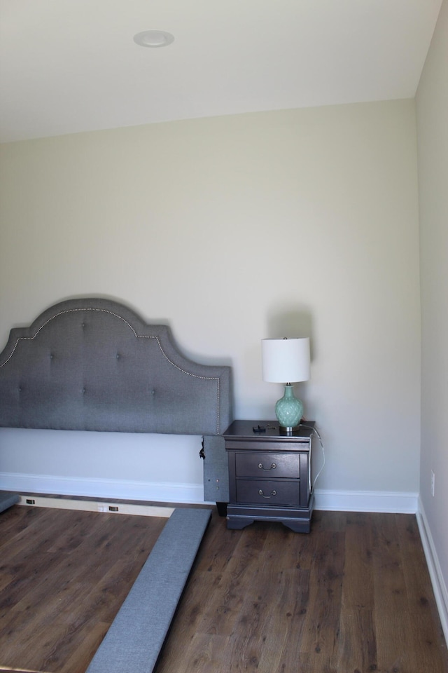 unfurnished bedroom featuring dark wood-type flooring