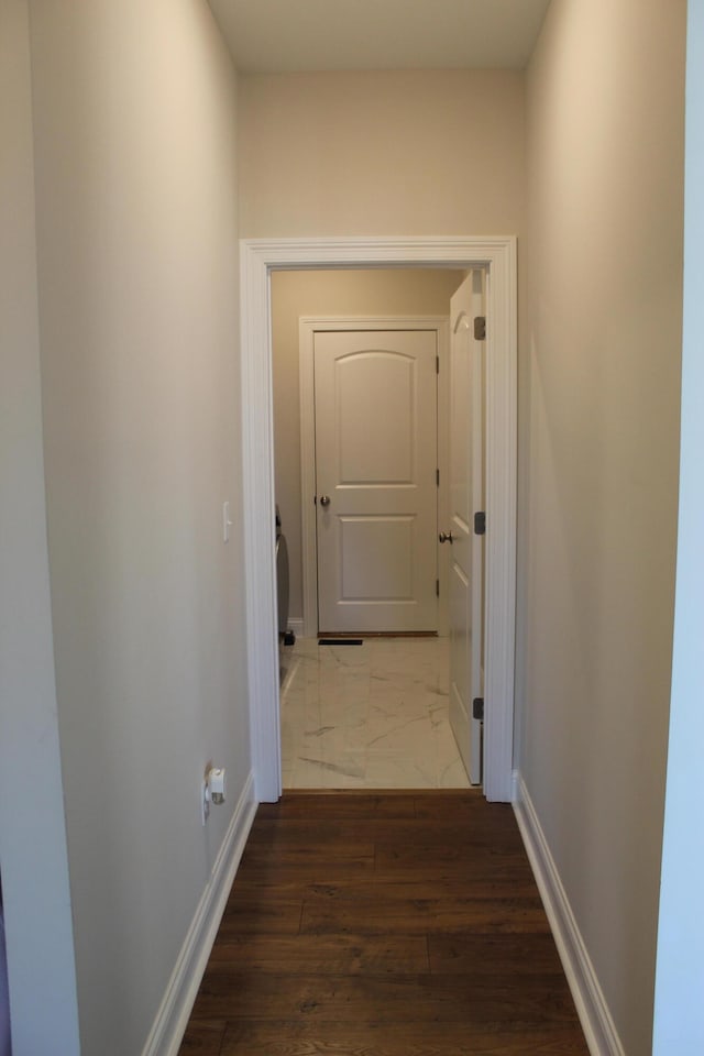 hallway with dark wood-type flooring