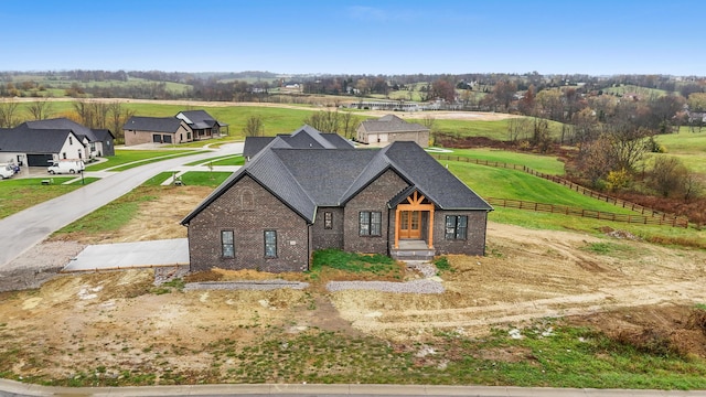 view of front of property with a front yard and a rural view