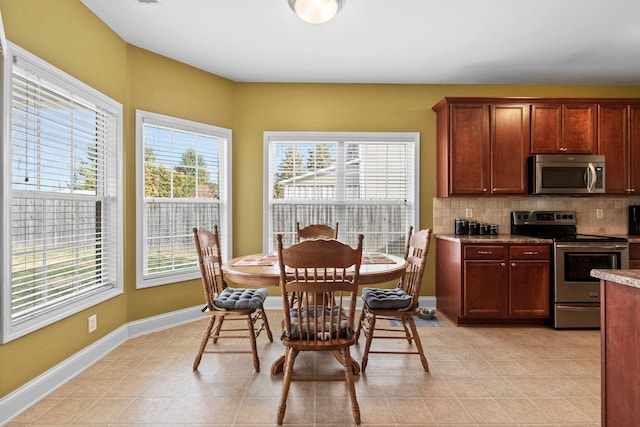 dining area with light tile patterned floors and baseboards