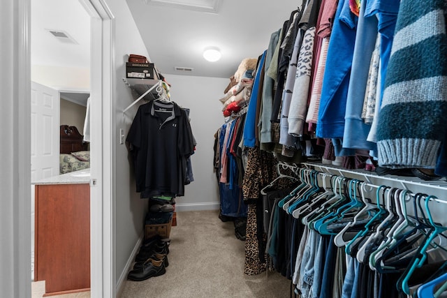 spacious closet with visible vents and carpet