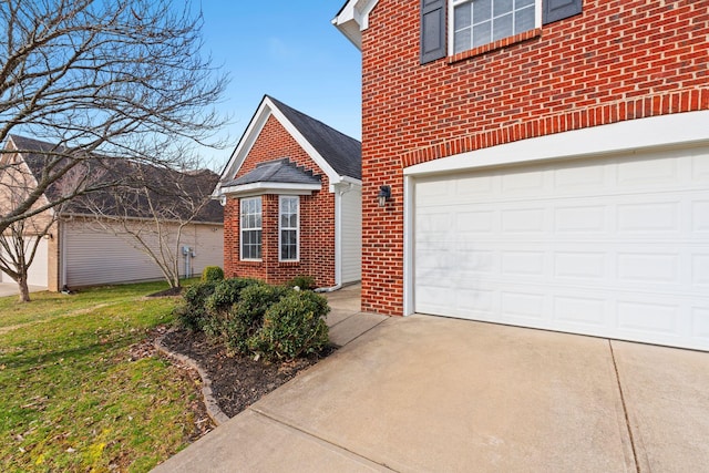 traditional-style house with a garage, brick siding, and driveway