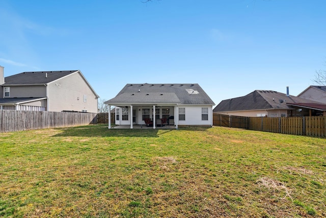 back of property featuring a patio area, a lawn, and a fenced backyard