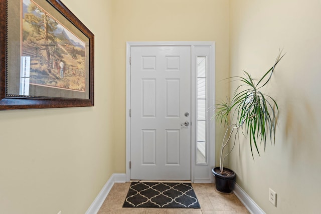 foyer entrance with baseboards and light tile patterned flooring