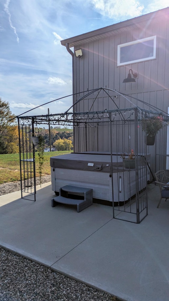 view of patio / terrace with a hot tub