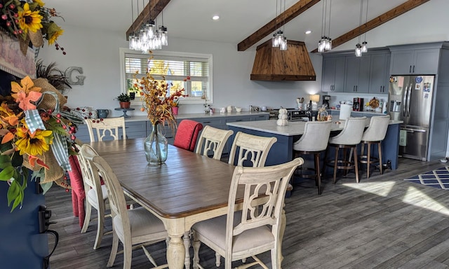 dining area with vaulted ceiling with beams and dark hardwood / wood-style floors