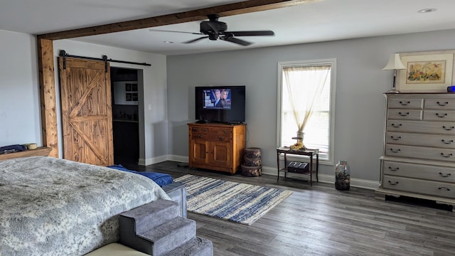 bedroom featuring a barn door, ceiling fan, beamed ceiling, and dark wood-type flooring