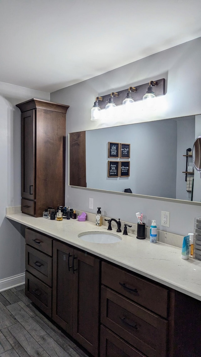 bathroom with hardwood / wood-style flooring and vanity