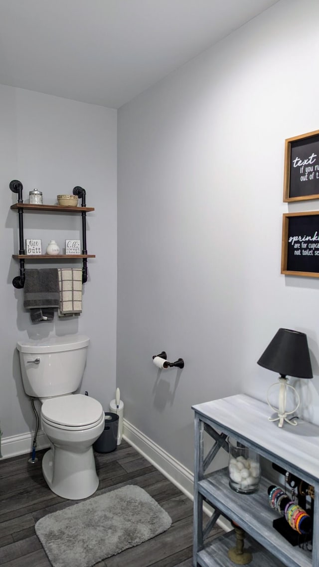 bathroom with toilet and hardwood / wood-style floors