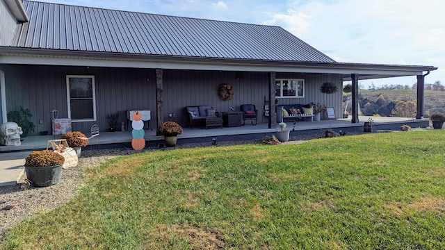 rear view of property with a deck, a yard, and an outdoor hangout area