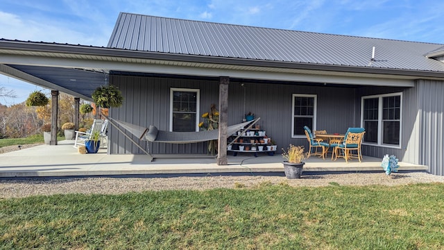 rear view of house with a patio area and a yard