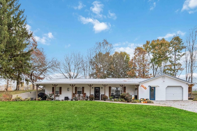 ranch-style house with a front lawn, a garage, and covered porch