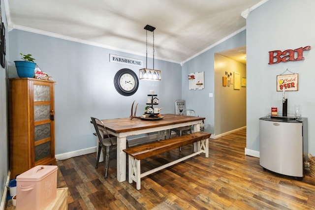 dining area with dark hardwood / wood-style flooring and crown molding