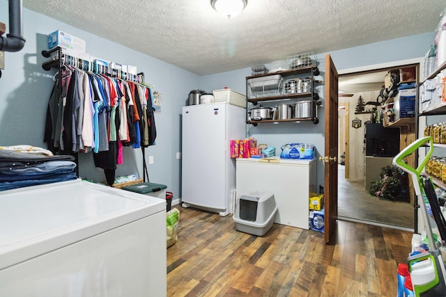 washroom featuring dark hardwood / wood-style flooring, a textured ceiling, and separate washer and dryer