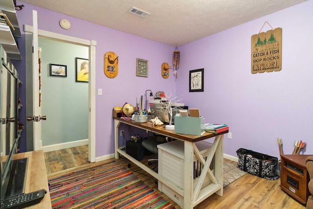 office area with hardwood / wood-style flooring and a textured ceiling