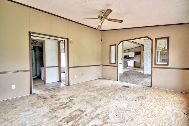 unfurnished room with ceiling fan, a textured ceiling, vaulted ceiling, and ornamental molding