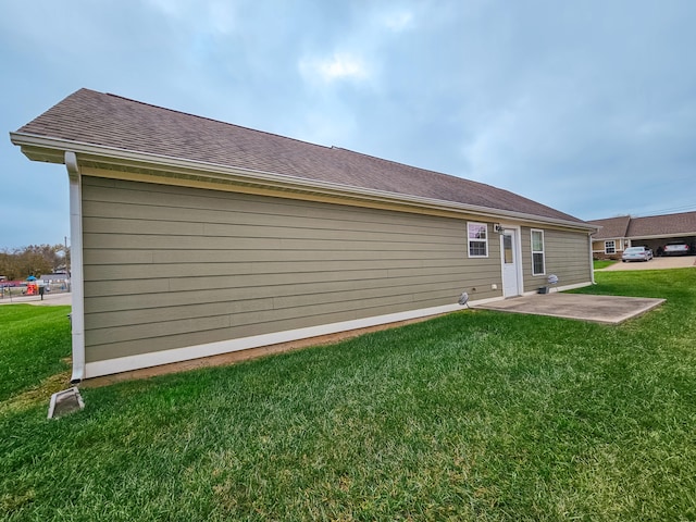 rear view of property with a yard and a patio area