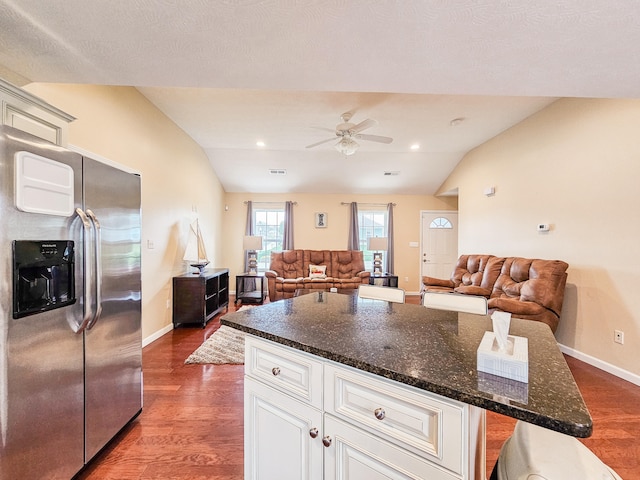 kitchen with white cabinetry, stainless steel refrigerator with ice dispenser, lofted ceiling, and dark hardwood / wood-style floors