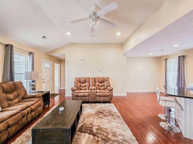 living room featuring ceiling fan, light wood-type flooring, and lofted ceiling