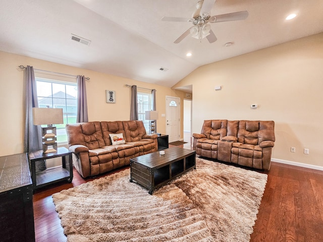 living room featuring dark hardwood / wood-style floors, ceiling fan, and vaulted ceiling