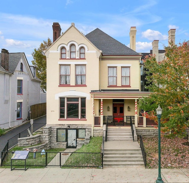 275 S Limestone Unit 310, Lexington, KY 40508 - multi unit property featuring covered porch, a fenced front yard, a chimney, and stucco siding
