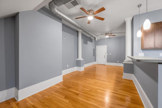 unfurnished living room featuring light wood-type flooring and ceiling fan