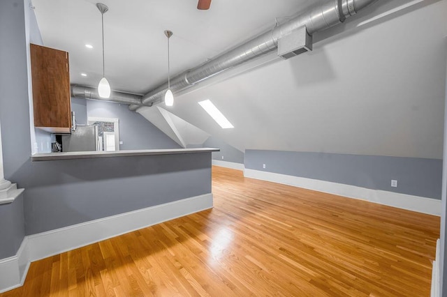 interior space featuring light hardwood / wood-style floors and lofted ceiling