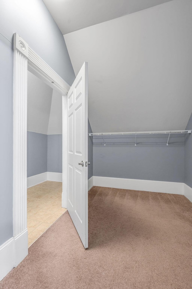 spacious closet with carpet and lofted ceiling