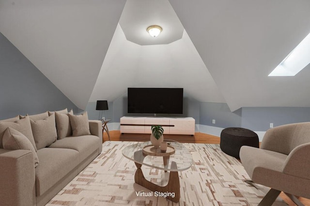 living room with vaulted ceiling with skylight and light hardwood / wood-style floors