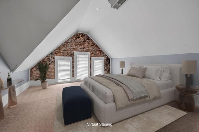 carpeted bedroom featuring vaulted ceiling and brick wall