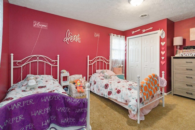 bedroom featuring a textured ceiling, a closet, and carpet floors