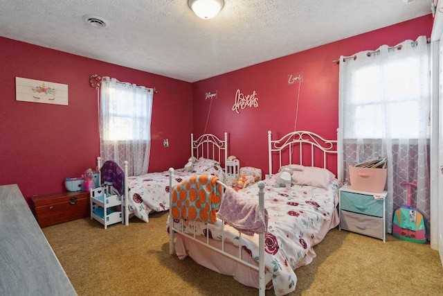 bedroom featuring carpet flooring and a textured ceiling