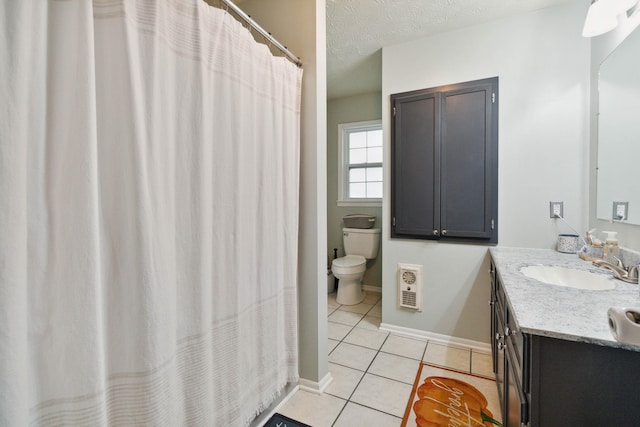 bathroom featuring tile patterned flooring, heating unit, a textured ceiling, vanity, and toilet