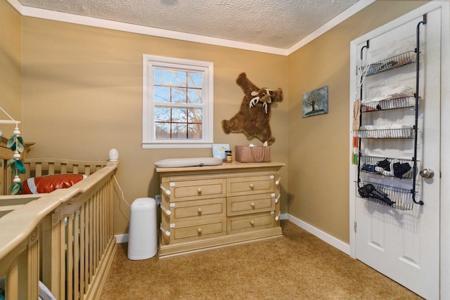 carpeted bedroom with a nursery area, a textured ceiling, and crown molding