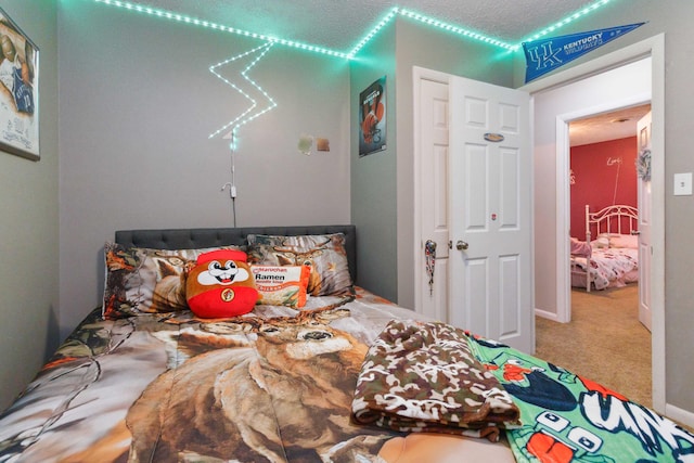 carpeted bedroom featuring a textured ceiling