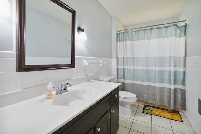 bathroom with tile walls, tile patterned floors, vanity, curtained shower, and toilet