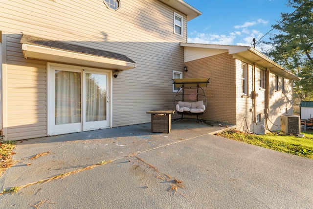 view of side of home featuring central AC and a patio area