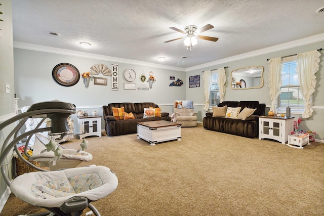 living room with ceiling fan, a textured ceiling, crown molding, and carpet