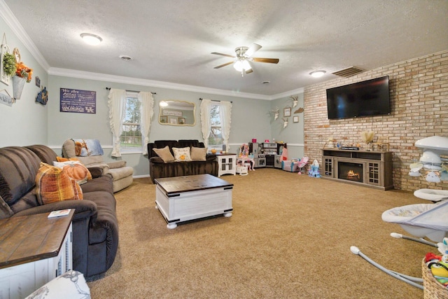 carpeted living room featuring a fireplace, a textured ceiling, ceiling fan, and crown molding