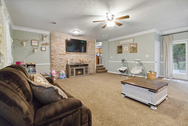 living room with a fireplace, crown molding, carpet floors, a textured ceiling, and ceiling fan