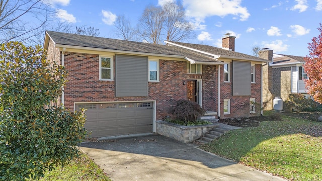 view of front of property featuring a garage and a front lawn