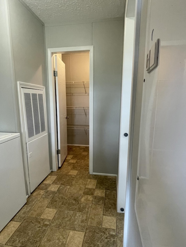 1455 Nepton Rd, Ewing, KY 41039 - hallway featuring dark stone finish floors and washer / dryer