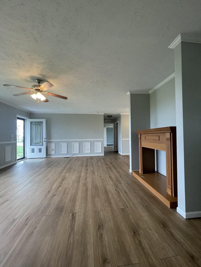 1455 Nepton Rd, Ewing, KY 41039 - unfurnished living room with dark wood-style floors, crown molding, a ceiling fan, a textured ceiling, and baseboards
