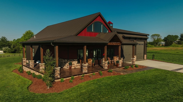 exterior space featuring a porch, a garage, and a front yard