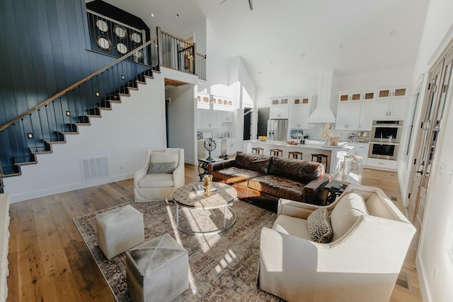 living room with a high ceiling and wood-type flooring