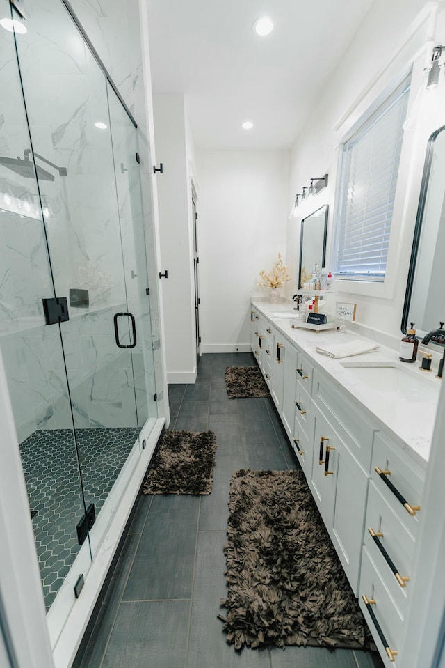 bathroom with tile patterned floors, a shower with door, and vanity