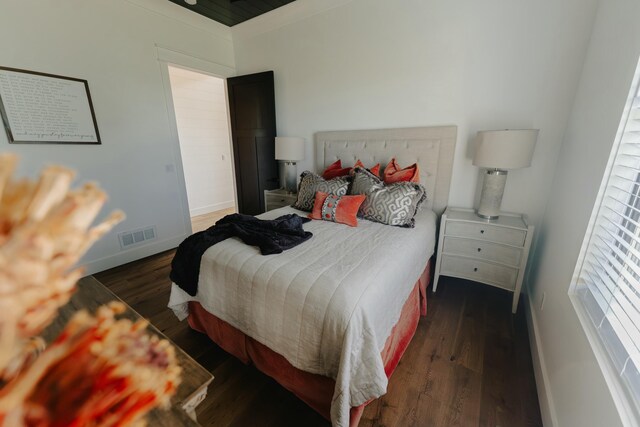 bedroom featuring dark hardwood / wood-style flooring