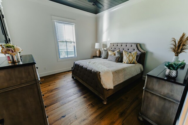 bedroom featuring ornamental molding and dark wood-type flooring